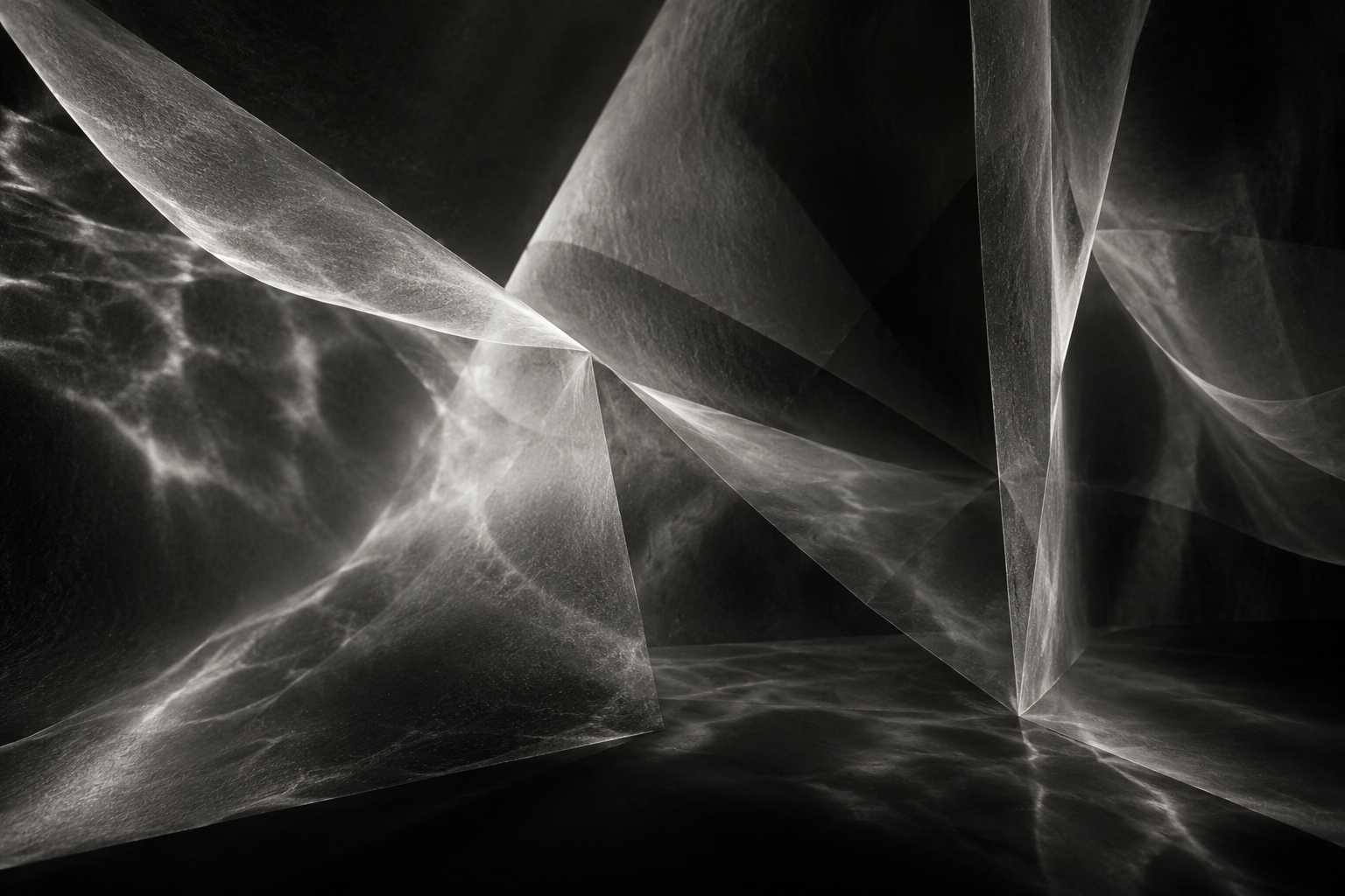 Monochrome abstract image of translucent planes, intersecting folds, light and shadow.